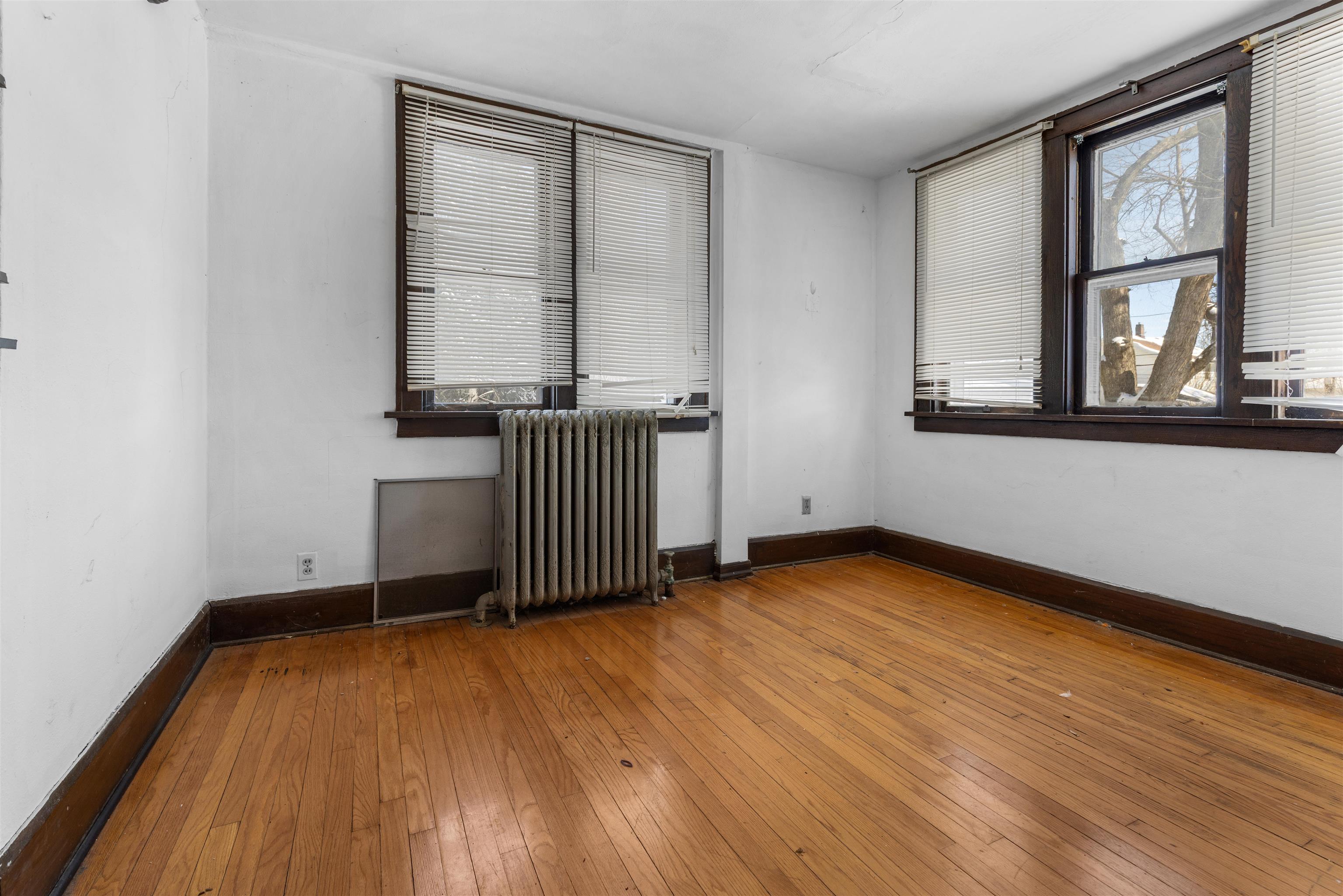 221 Rome Avenue Rockford, IL 61107 - Photo 13 of 26 an empty room with wooden floor and windows