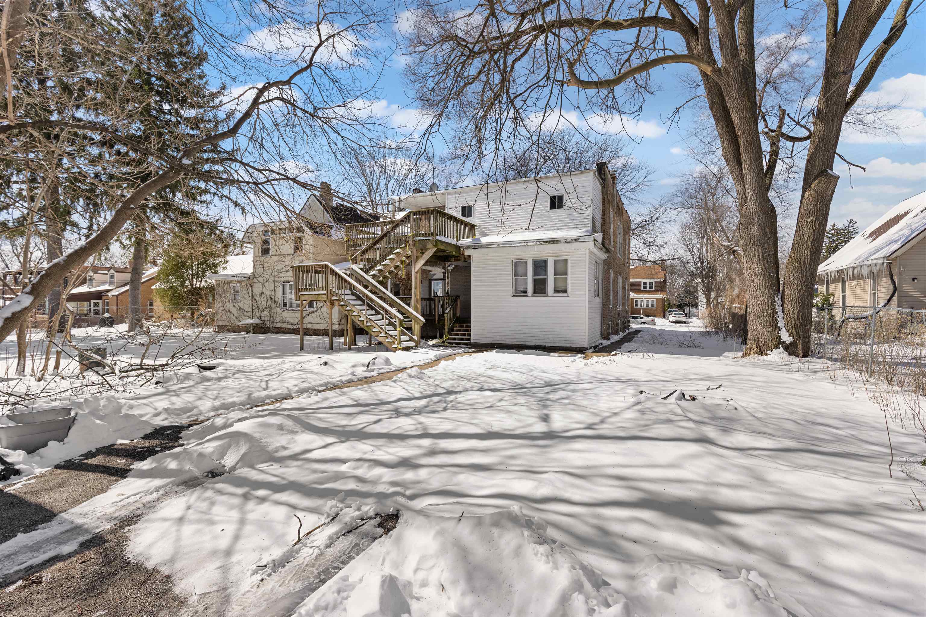 221 Rome Avenue Rockford, IL 61107 - Photo 2 of 26 a view of a white house with a snow on the road