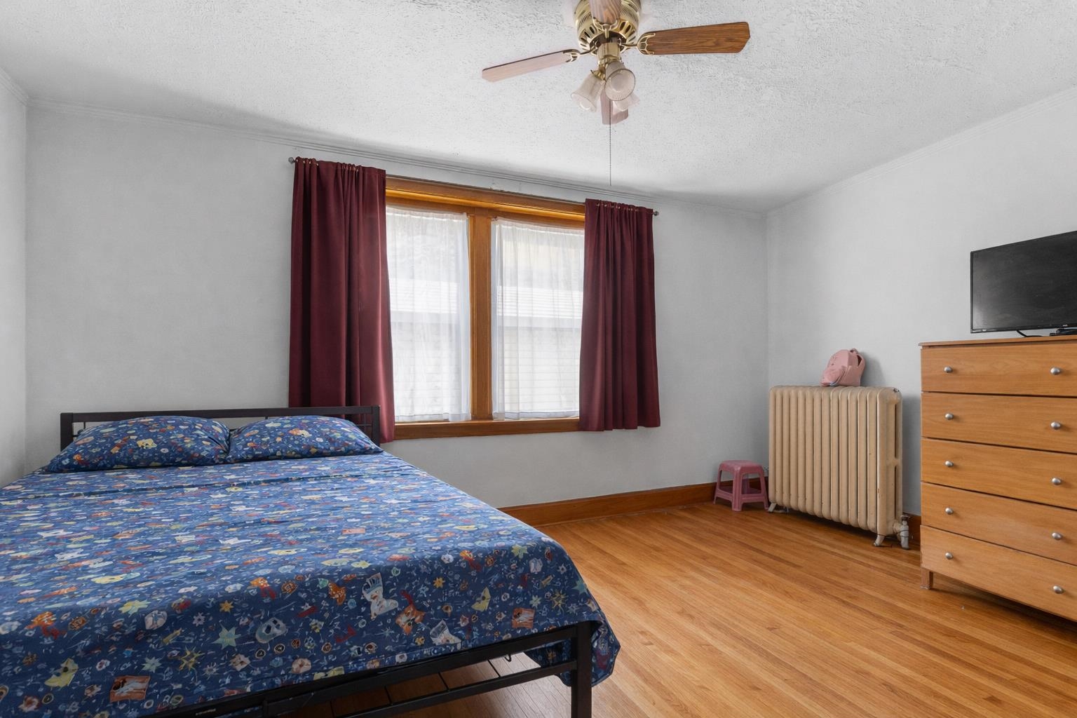 221 Rome Avenue Rockford, IL 61107 - Photo 23 of 26 a bedroom with a bed and a flat screen tv