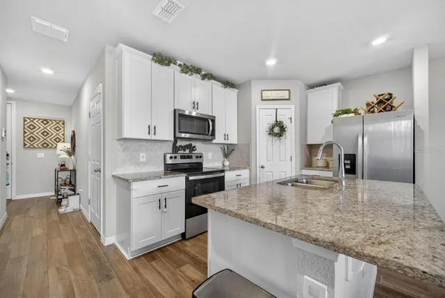 a living room with furniture and kitchen view