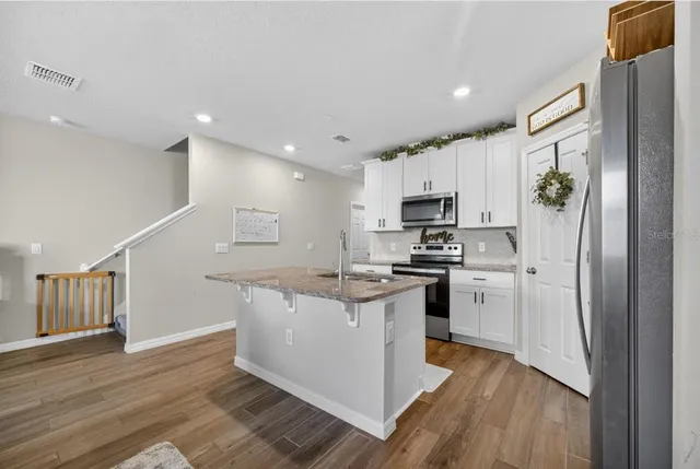 a living room with furniture and a ceiling fan