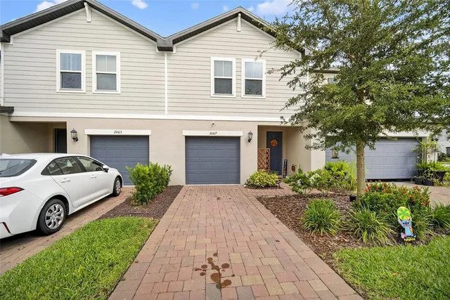 an aerial view of residential building and ocean view in back