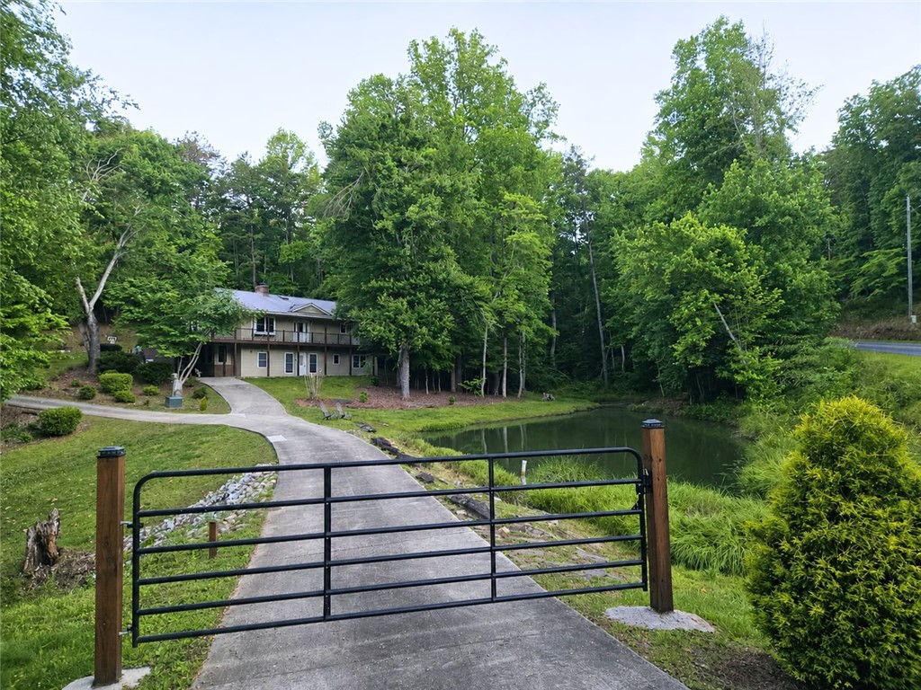 130 Greenbrier Road Salem, SC 29676 - Photo 47 of 48 A tranquil pond and lush trees frame this home, offering a private, verdant setting.