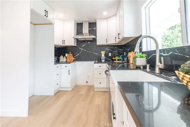 a kitchen with stainless steel appliances kitchen island sink stove and cabinets