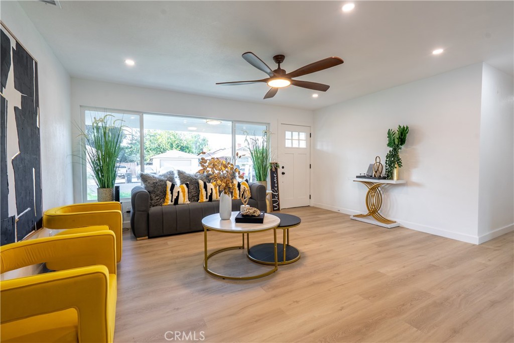 7516 San Juan Avenue Riverside, CA 92504 - Photo 2 of 43 a living room with furniture a flat screen tv and a large window