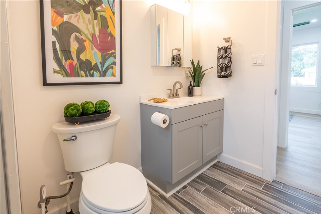 7516 San Juan Avenue Riverside, CA 92504 - Photo 22 of 43 a bathroom with a toilet sink and mirror