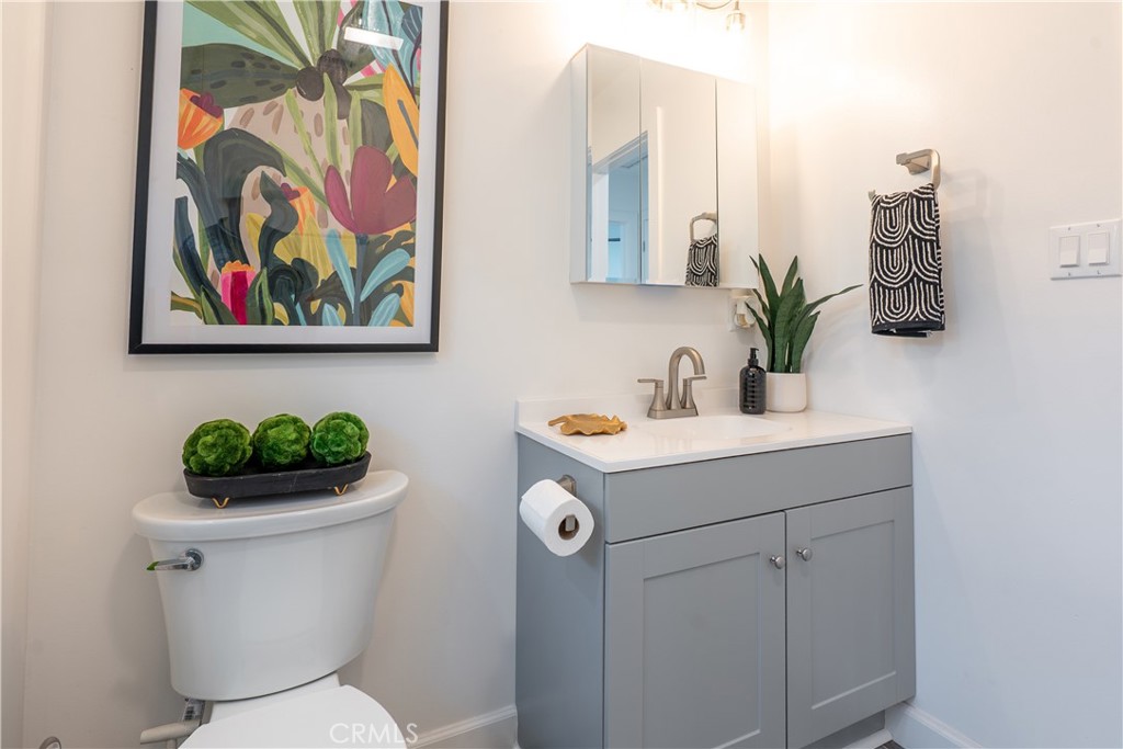 7516 San Juan Avenue Riverside, CA 92504 - Photo 23 of 43 a bathroom with a sink mirror and toilet