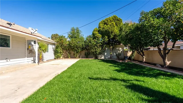 a view of a house with a garden and pathway