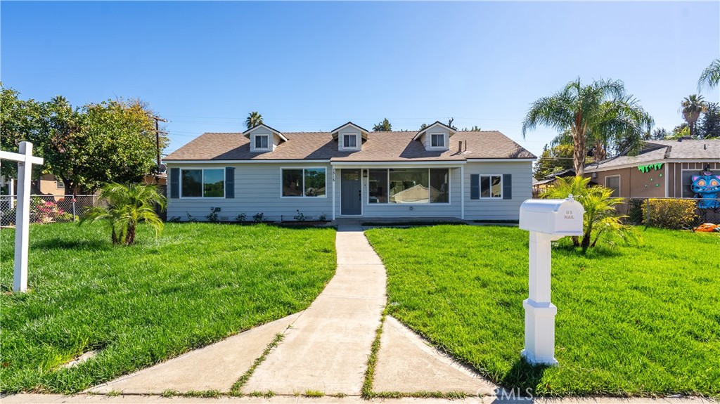7516 San Juan Avenue Riverside, CA 92504 - Photo 42 of 43 a front view of a house with a yard and potted plants