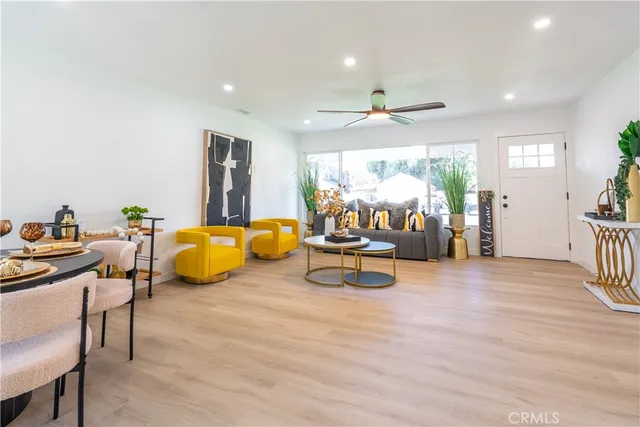 a bedroom with furniture and a large window