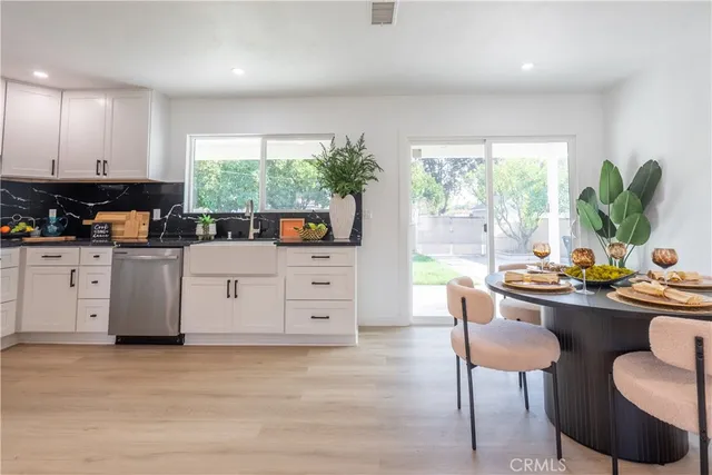a room with furniture a large window and wooden floor