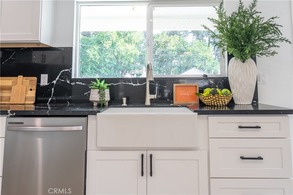 7516 San Juan Avenue Riverside, CA 92504 - Photo 9 of 43 a kitchen with a stove a sink and a potted plant