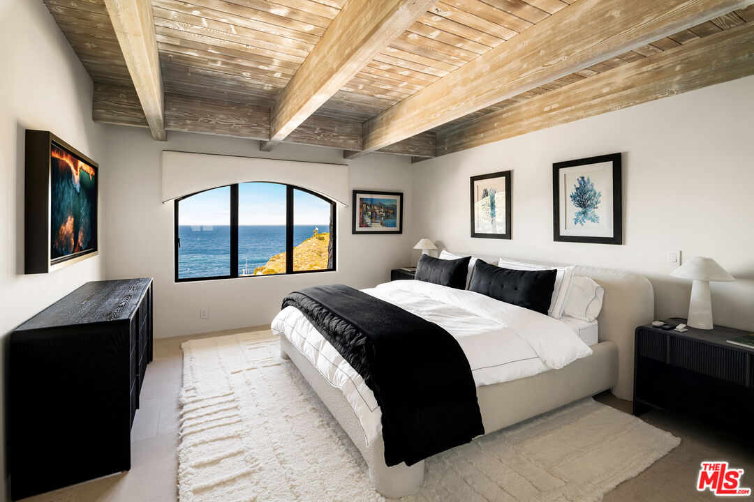 335 Wrigley Road Avalon, CA 90704 - Photo 34 of 69 a spacious bedroom with a large bed and a large window