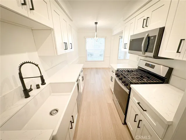 a kitchen with stainless steel appliances granite countertop a stove and a sink