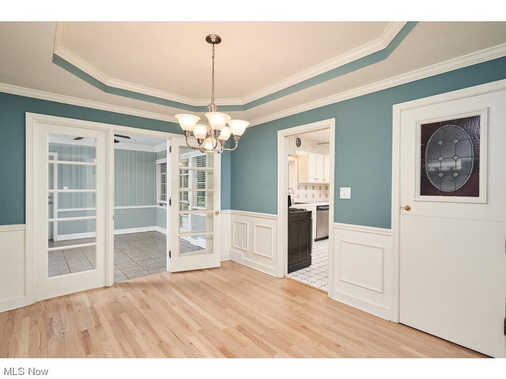 2468 Ridgewood Road Akron, OH 44313 - Photo 8 of 21 Wood floored spare room with crown molding and a tray ceiling