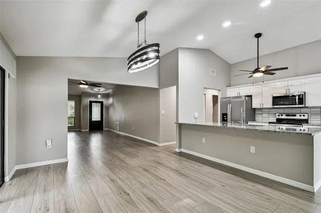 a stove top oven sitting inside of a kitchen