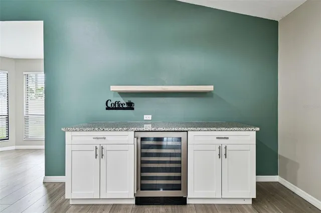 a kitchen with stainless steel appliances granite countertop a sink and a refrigerator
