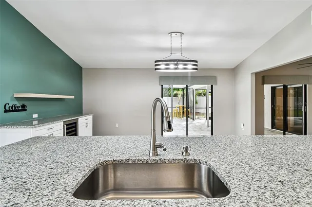 a bathroom with a granite countertop toilet a sink and a mirror