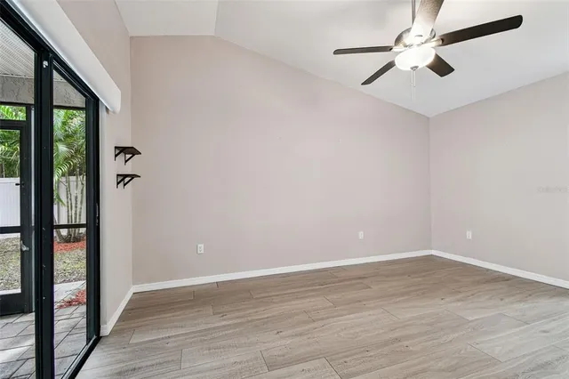 a view of an empty room with wooden floor