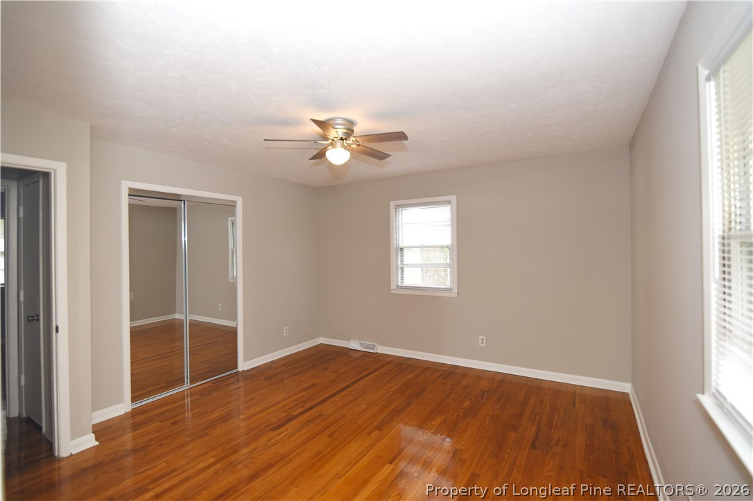 1673 Norment Road Lumberton, NC 28360 - Photo 23 of 32 an empty room with wooden floor and window
