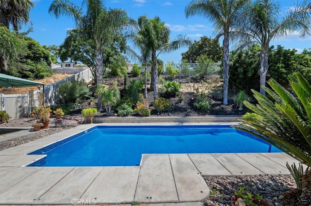 44938 Tehachapi Pass Temecula, CA 92592 - Photo 1 of 1 a view of swimming pool on a sunny day with lawn chairs
