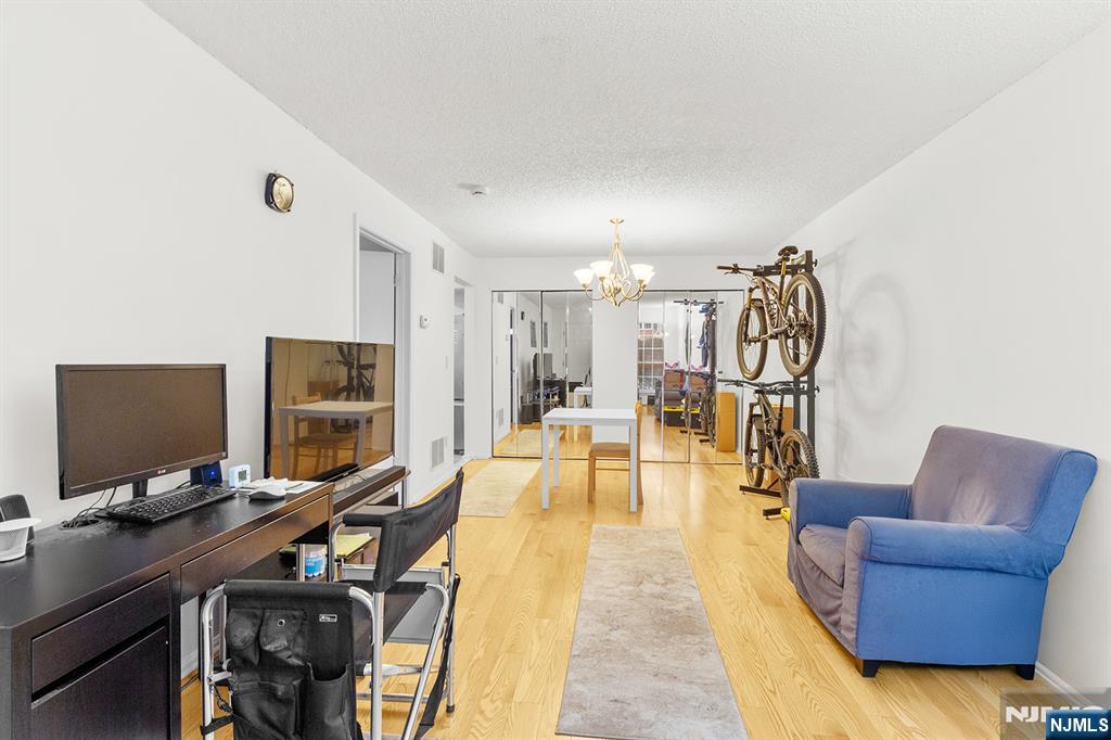 696 Pepperidge Road Mahwah, NJ 07430 - Photo 3 of 14 a view of a livingroom with workspace and a flat screen tv