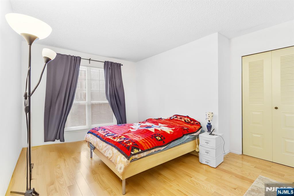 696 Pepperidge Road Mahwah, NJ 07430 - Photo 8 of 14 a bedroom with a bed and a chandelier