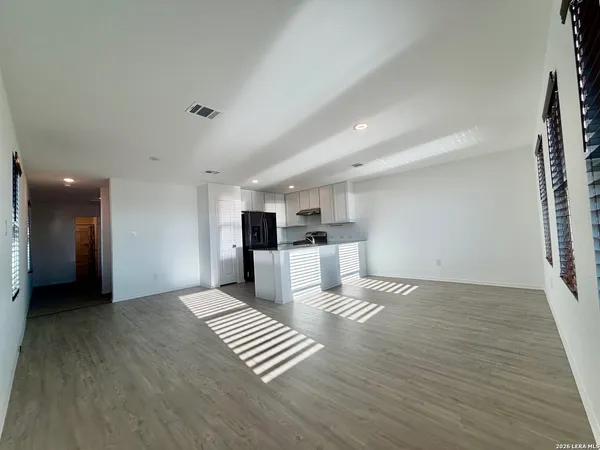 a view of kitchen with furniture and refrigerator