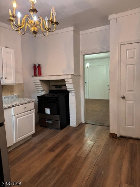 46 Myrtle Avenue Newark, NJ 07107 - Photo 4 of 10 a kitchen with granite countertop a stove and cabinets