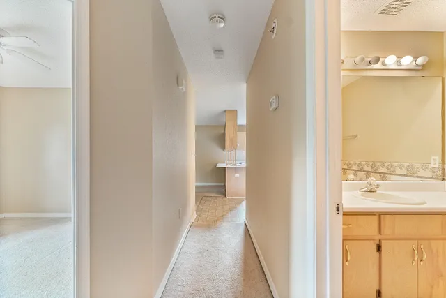 an empty room with a large window & entryway