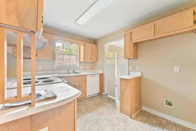 a kitchen with a sink stove and cabinets