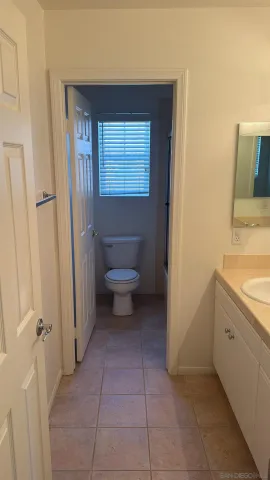 a view of room with refrigerator and white walls