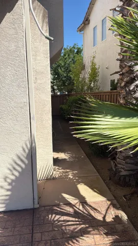 a view of an empty room with a fireplace and a window