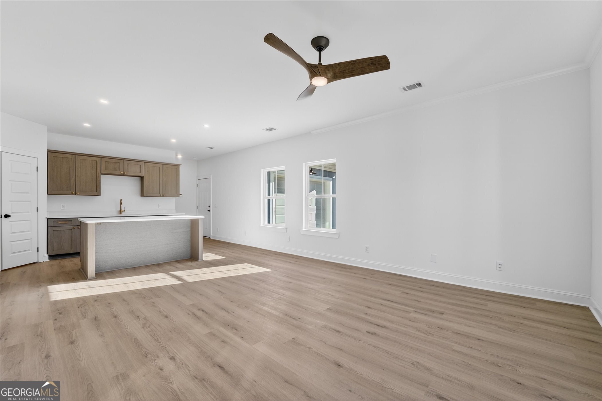 1058 Cottage Way Darien, GA 31305 - Photo 3 of 20 a view of a big room with wooden floor and windows