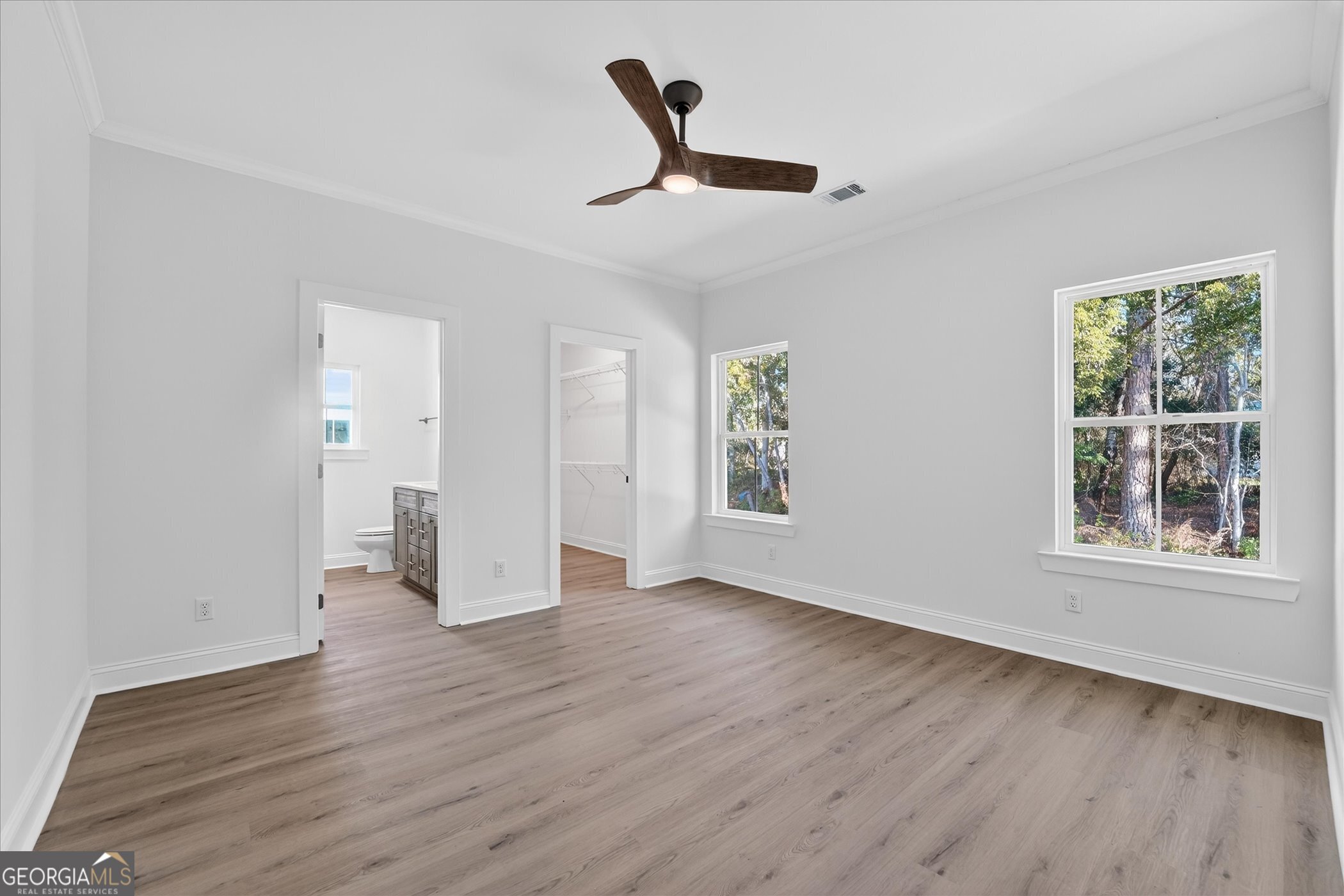 1058 Cottage Way Darien, GA 31305 - Photo 4 of 20 a view of an empty room with wooden floor and a window