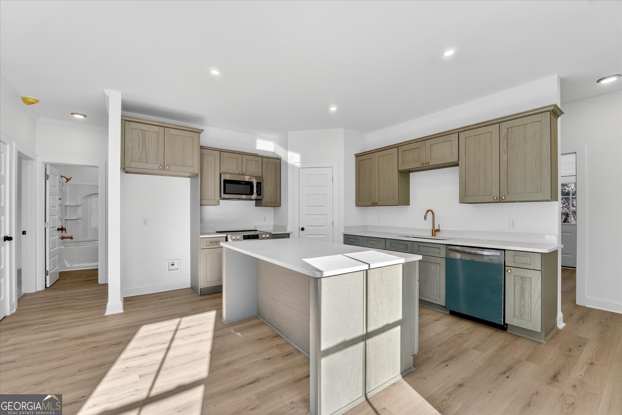 1058 Cottage Way Darien, GA 31305 - Photo 5 of 20 a kitchen with stainless steel appliances a sink a stove a refrigerator and cabinets