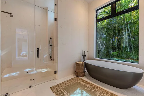 a bathroom with a bathtub and a shower