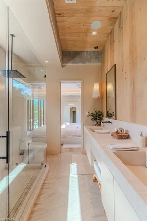 a large white bathroom with a large tub and shower