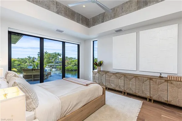 a bedroom with a large bed and a large window