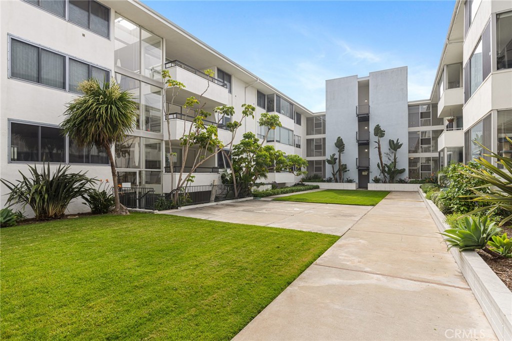 8701 Delgany Avenue, Unit 110 Playa del Rey, CA 90293 - Photo 20 of 22 a view of a building with a yard