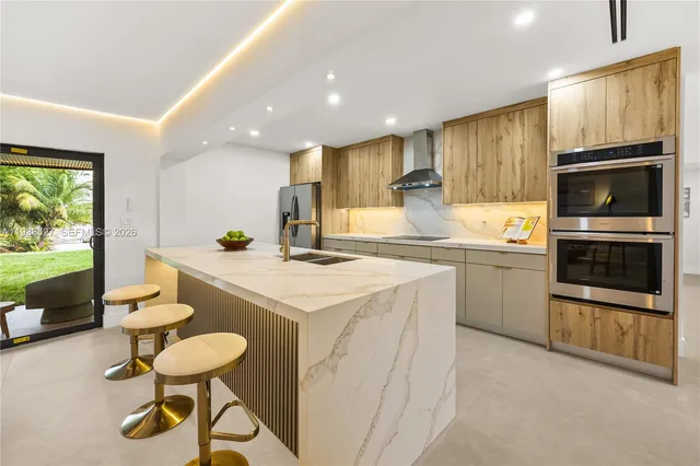 a kitchen with a sink a counter and chairs