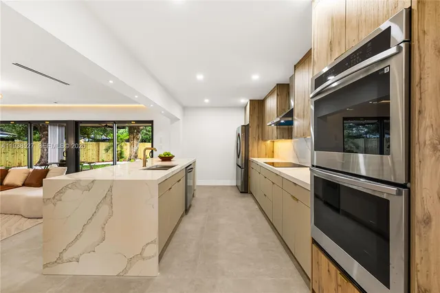 a large white room with double vanity and a large window