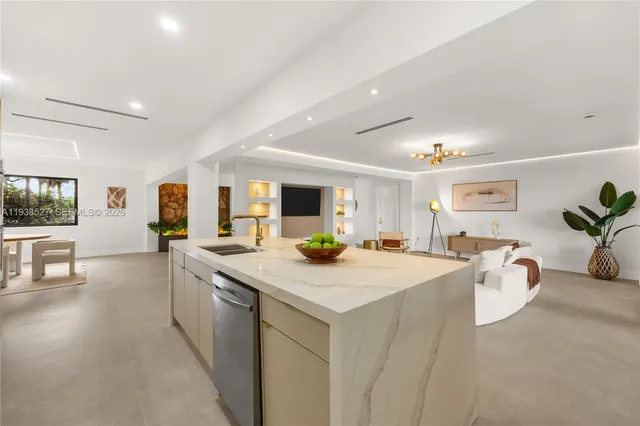a view of a kitchen counter top space sink and living room