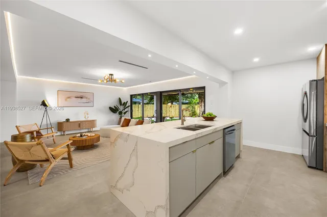 a view of kitchen with furniture and refrigerator