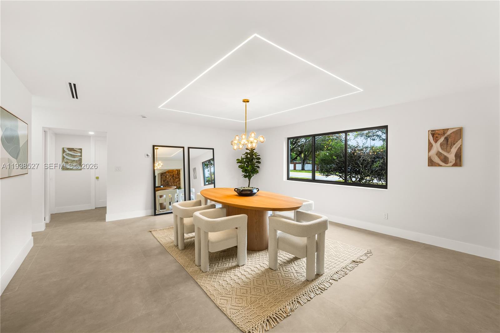 10415 Southwest 87th Avenue Miami, FL 33156 - Photo 21 of 53 a living room with furniture a chandelier and a large window