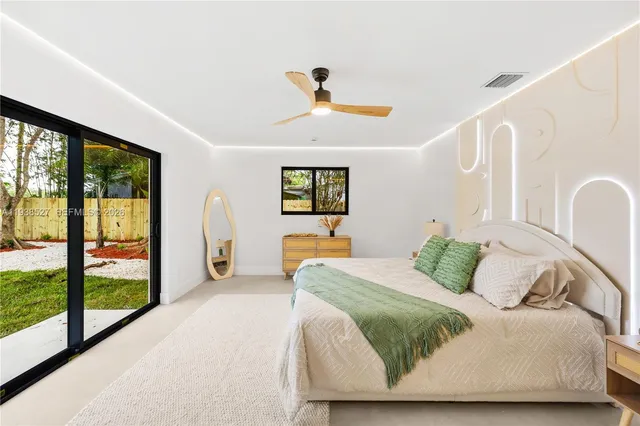 a bedroom with a large bed and a window