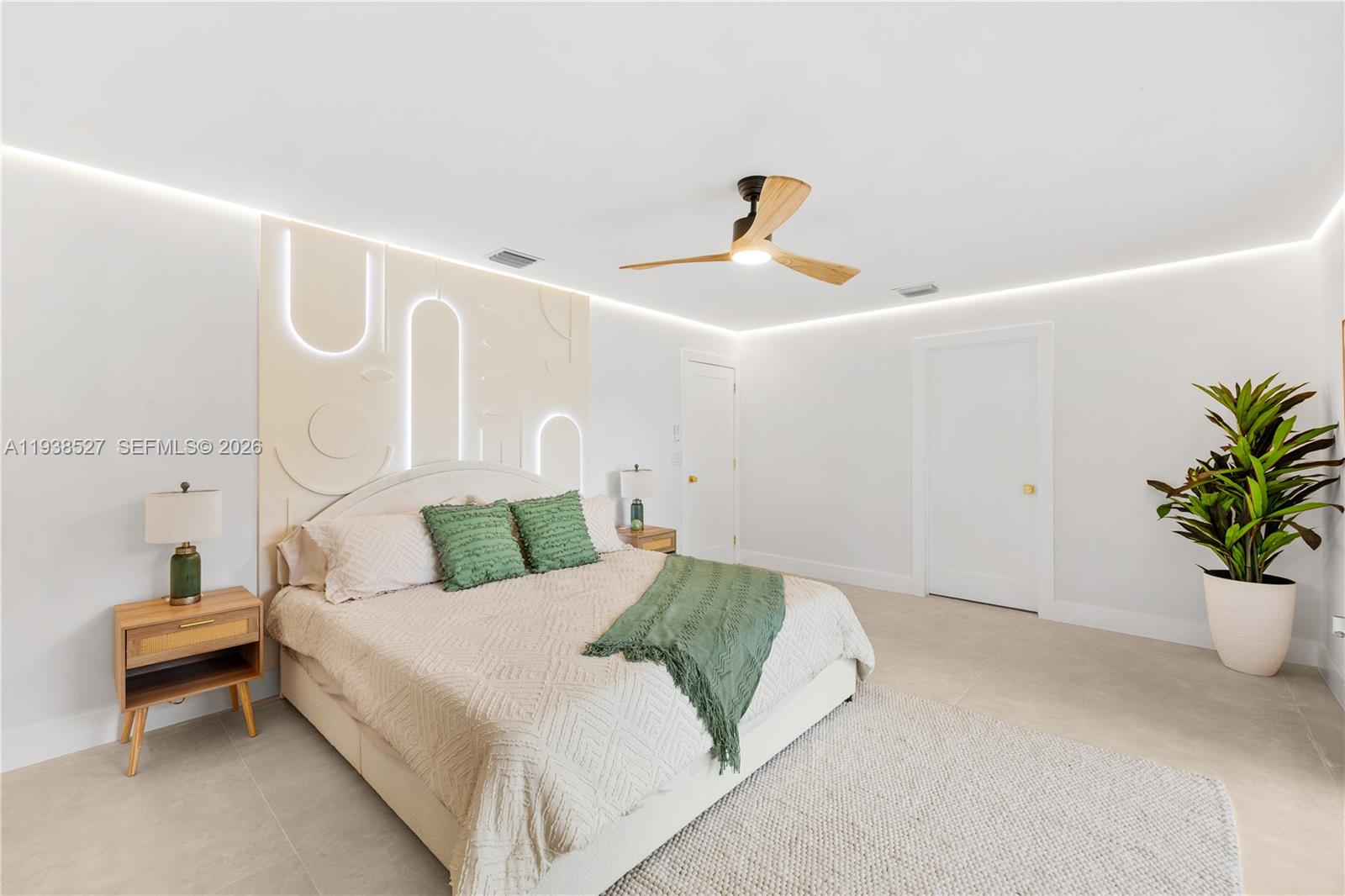 10415 Southwest 87th Avenue Miami, FL 33156 - Photo 24 of 53 a bedroom with a bed and a potted plant