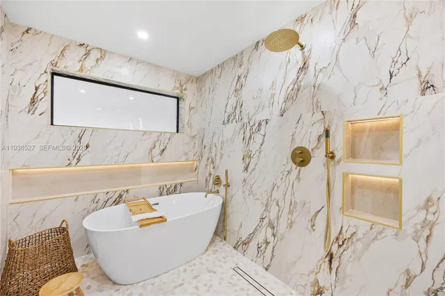 a bath tub sitting next to a bathroom sink