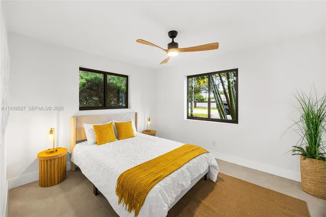 a bedroom with a bed and a potted plant