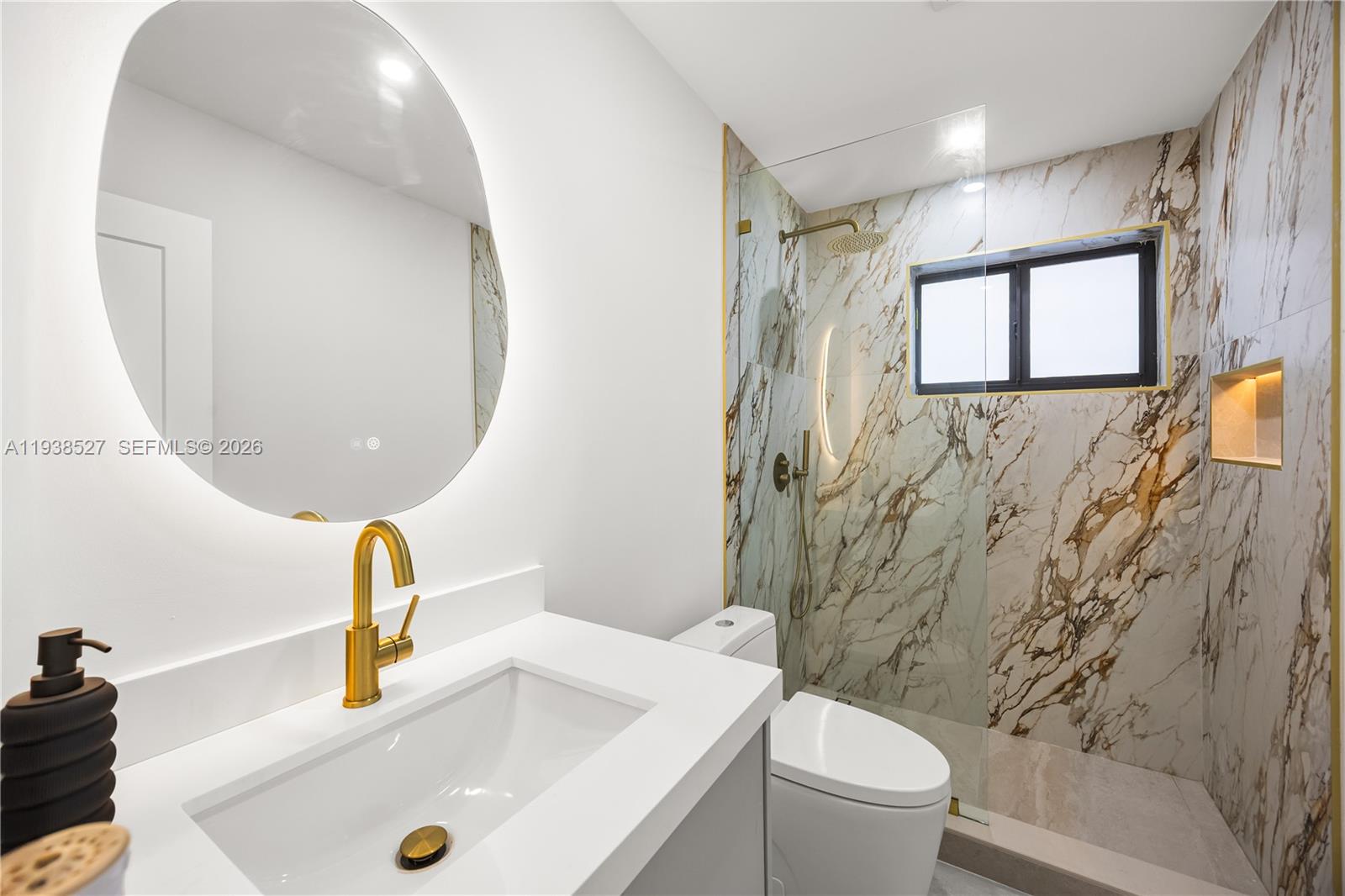 10415 Southwest 87th Avenue Miami, FL 33156 - Photo 32 of 53 a bathroom with a sink a toilet and a mirror